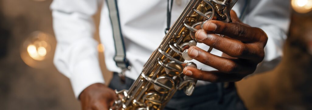 Male jazz performer plays the saxophone on stage